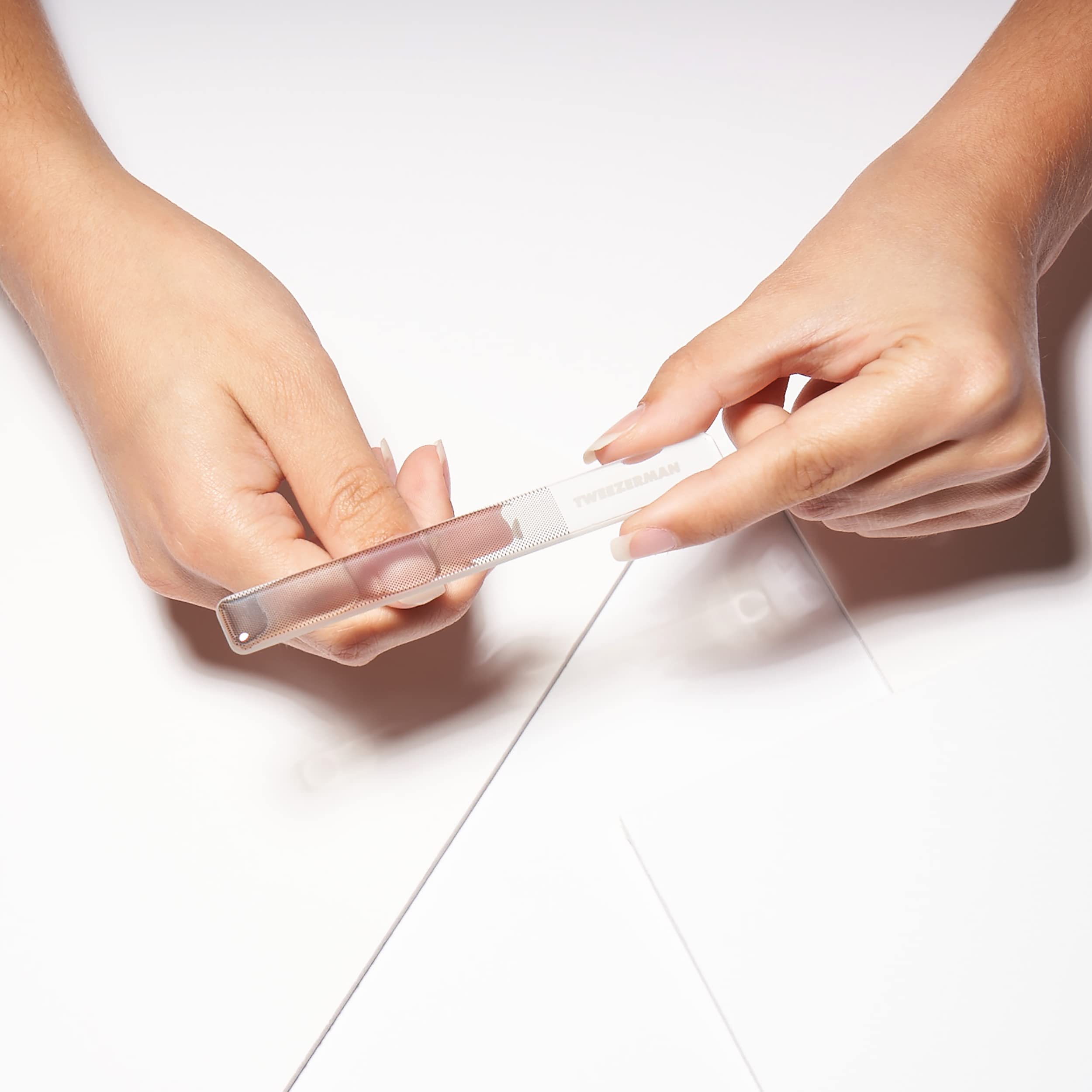 Tweezerman Glass Manicure Set flat edge push-back cuticles for tidy nail prep.