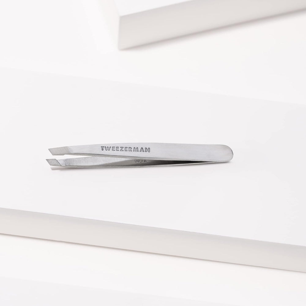 Tweezerman Mini Slant Tweezer angled for easy pull with hair growth direction.