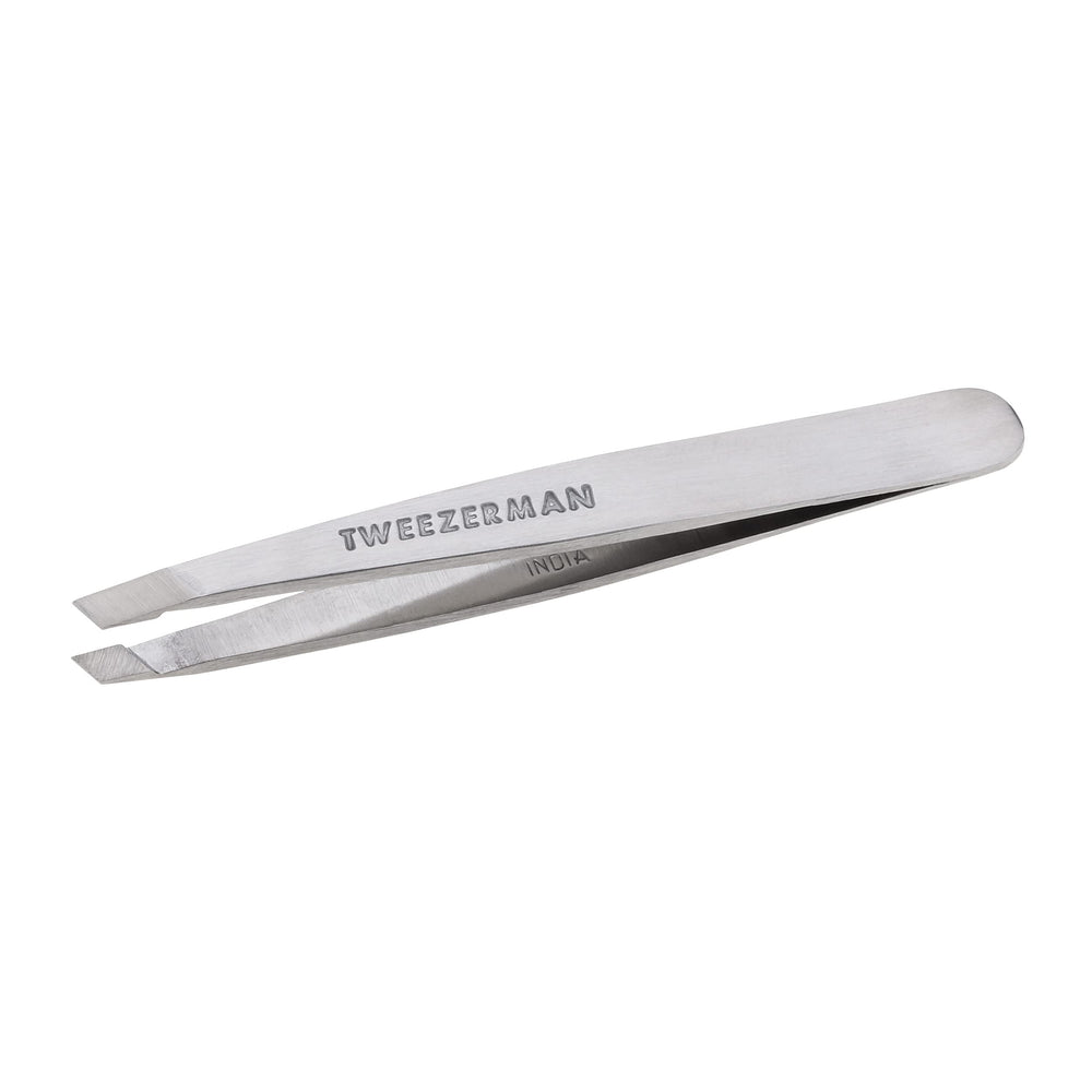 Tweezerman Mini Slant Tweezer held to show controlled grip and precision.