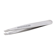 Tweezerman Mini Slant Tweezer held to show controlled grip and precision.