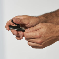 Tweezerman Precision Grip Fingernail Clipper in black case catching clippings during use.