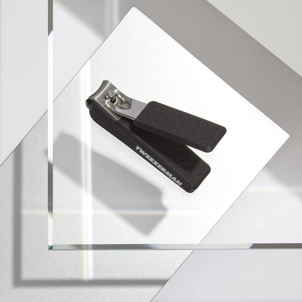 Tweezerman Precision Grip Fingernail Clipper in black with textured handle for comfort and control.