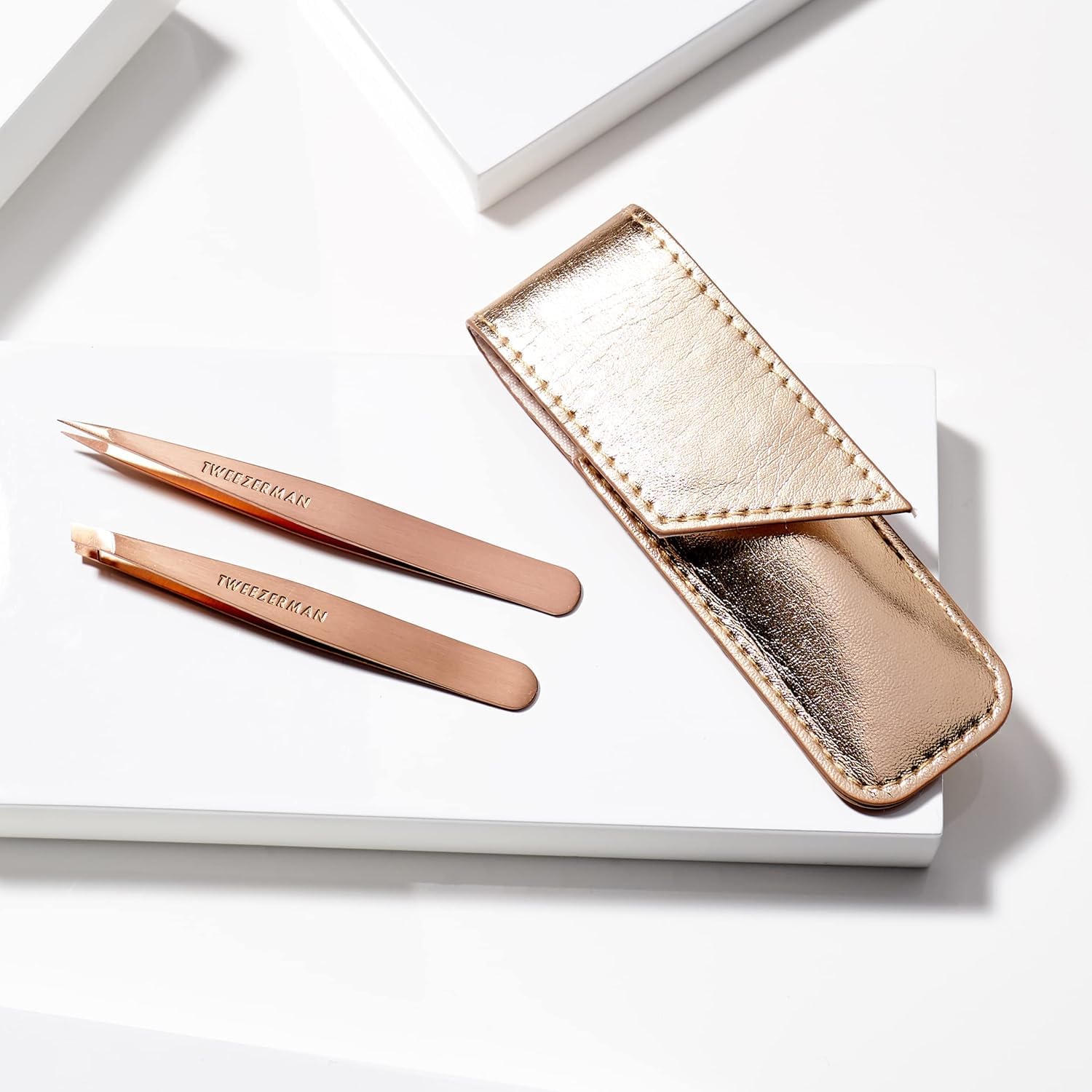 Rose Gold Tweezers perform precise brow shaping and grooming.