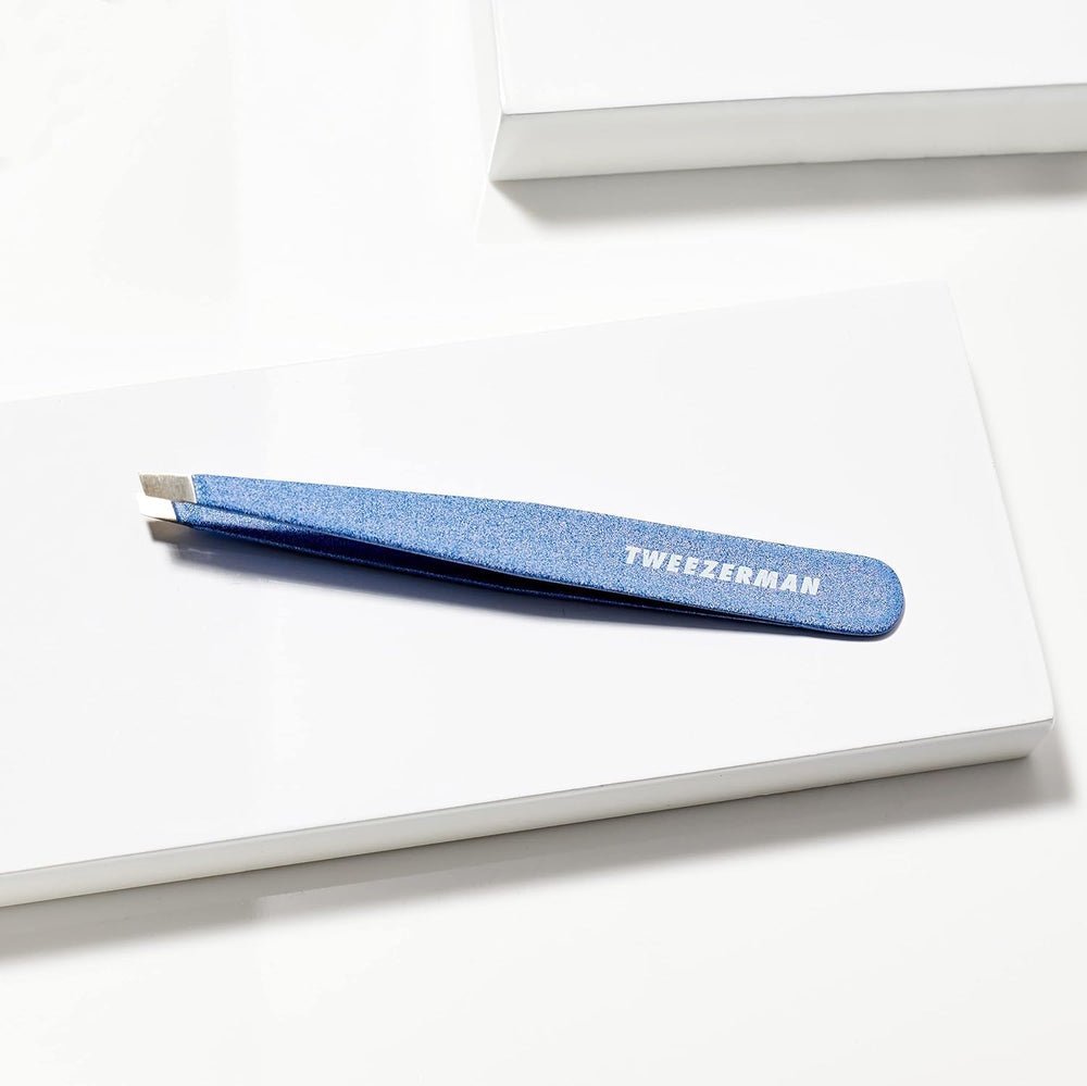 Tweezerman sky blue handle slant tweezer in use for grooming