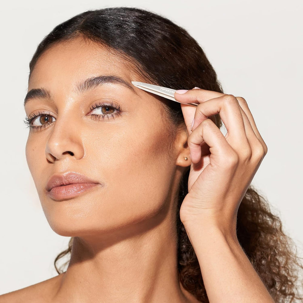 Tweezerman slant tweezer in action pulling stray brow hair.