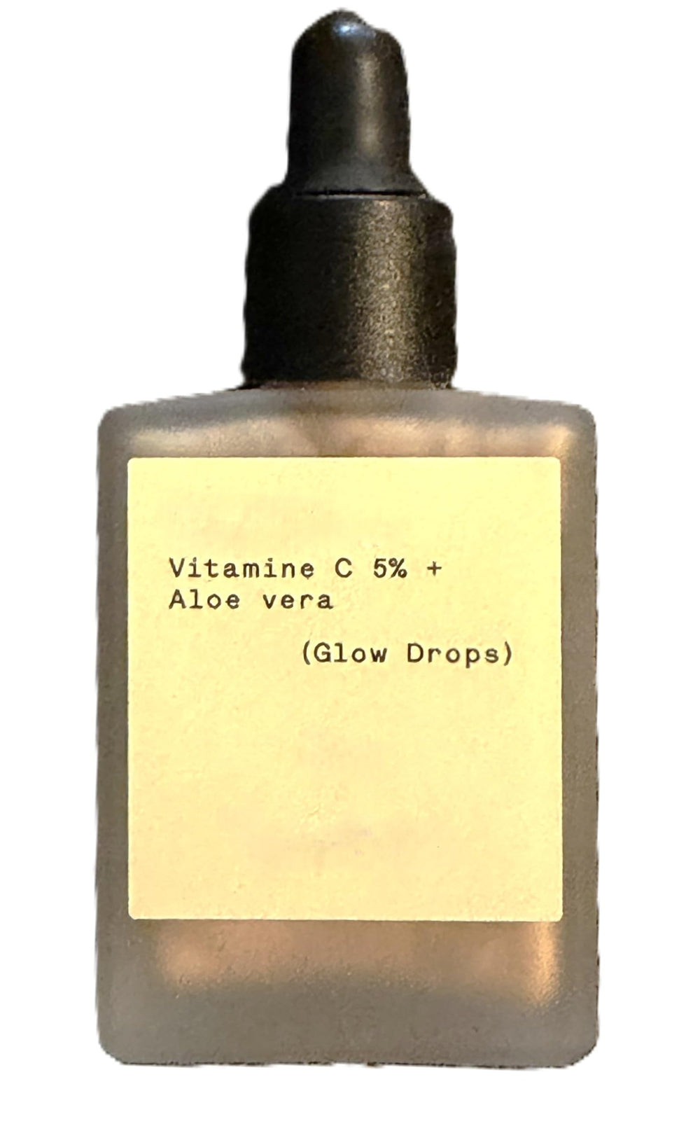 Typology Glow Drops bottle close-up showing vegan vitamin C serum for radiant skin.
