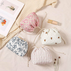 Uekeboag makeup bag open with drawstring closure enables quick access while traveling.
