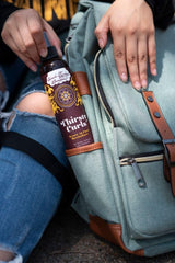 Uncle Funky's Daughter Thirsty Curls leave-in mist being spritzed on curls for moisture