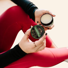 Untamed Organics balm hand-application showing moisturizer for dry skin.