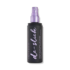 Urban Decay De-Slick bottle front shows oil-control matte setting spray.