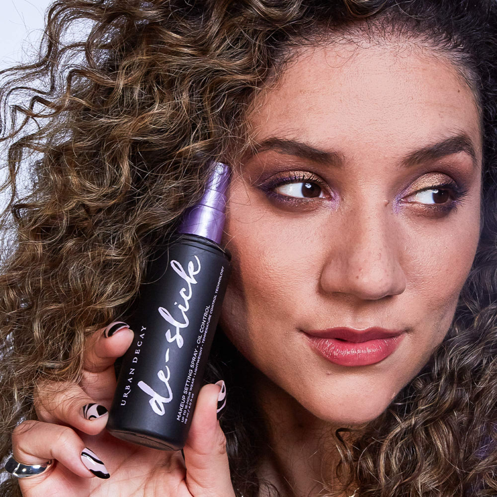 Urban Decay De-Slick mist dispense demonstrates a fine weightless spray.