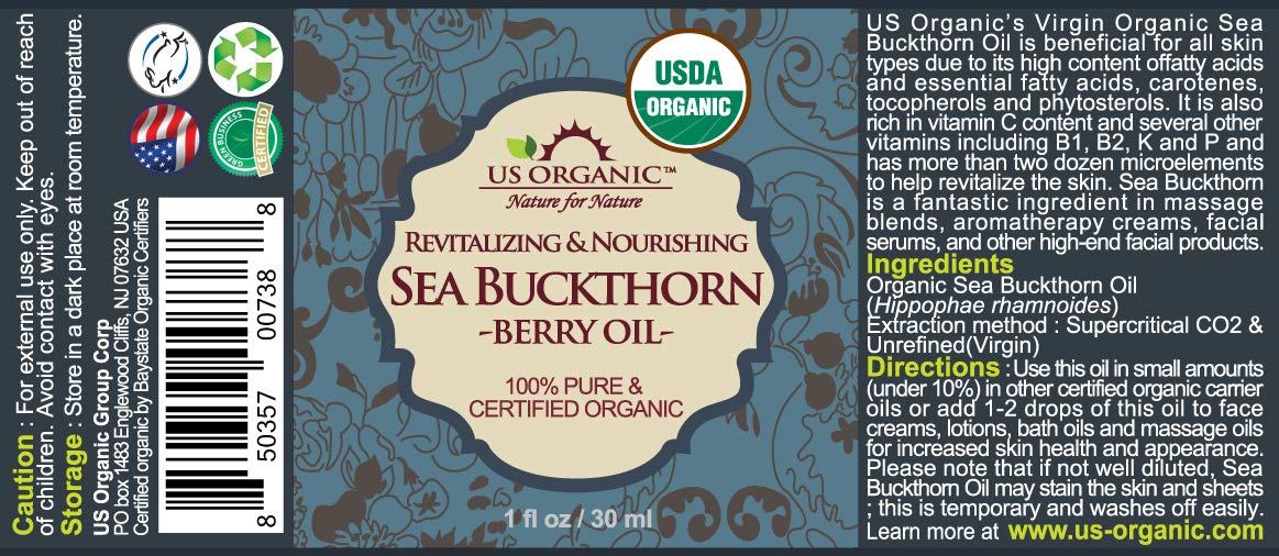 Close-up of US Organic sea buckthorn oil in amber bottle showing vibrant color.