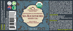 Close-up of US Organic sea buckthorn oil in amber bottle showing vibrant color.