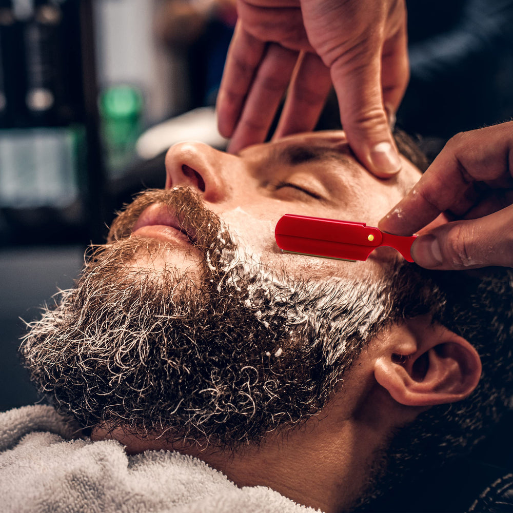 Utopia Care straight razor red closeup showcases precision machining and steady shave potential.