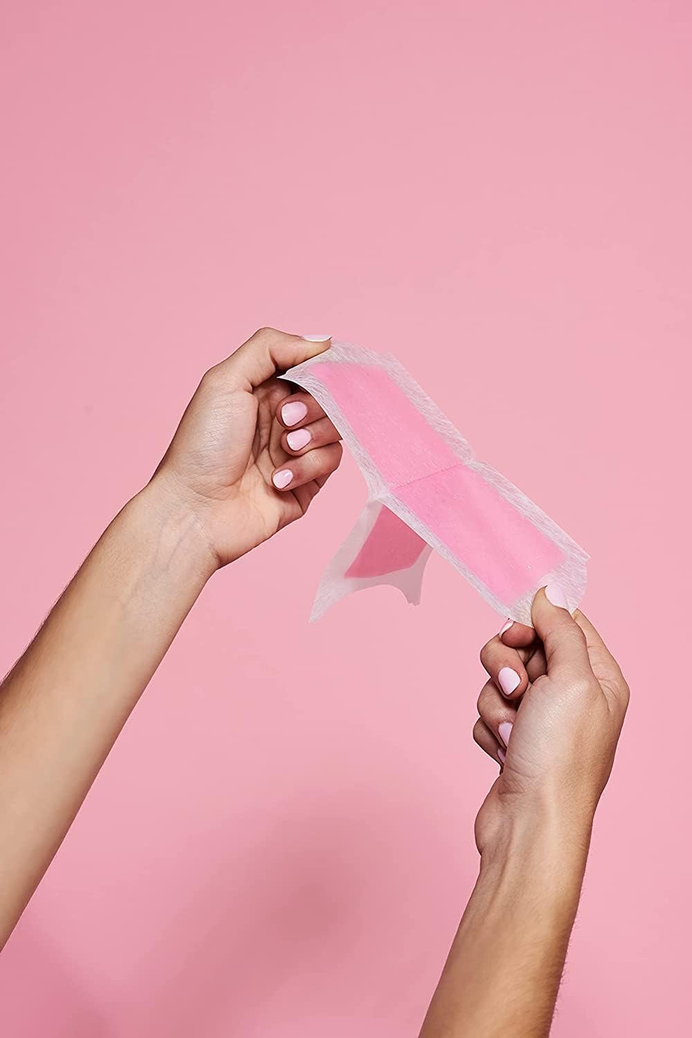 Veet wax strip close-up shows grip and removal of hair near the root