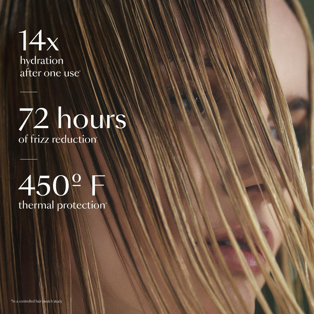 Spraying HYDR-8 on damp hair and combing through for even distribution.