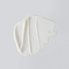 Creamy Day Maker cleanser texture on hand showing luxurious spread.