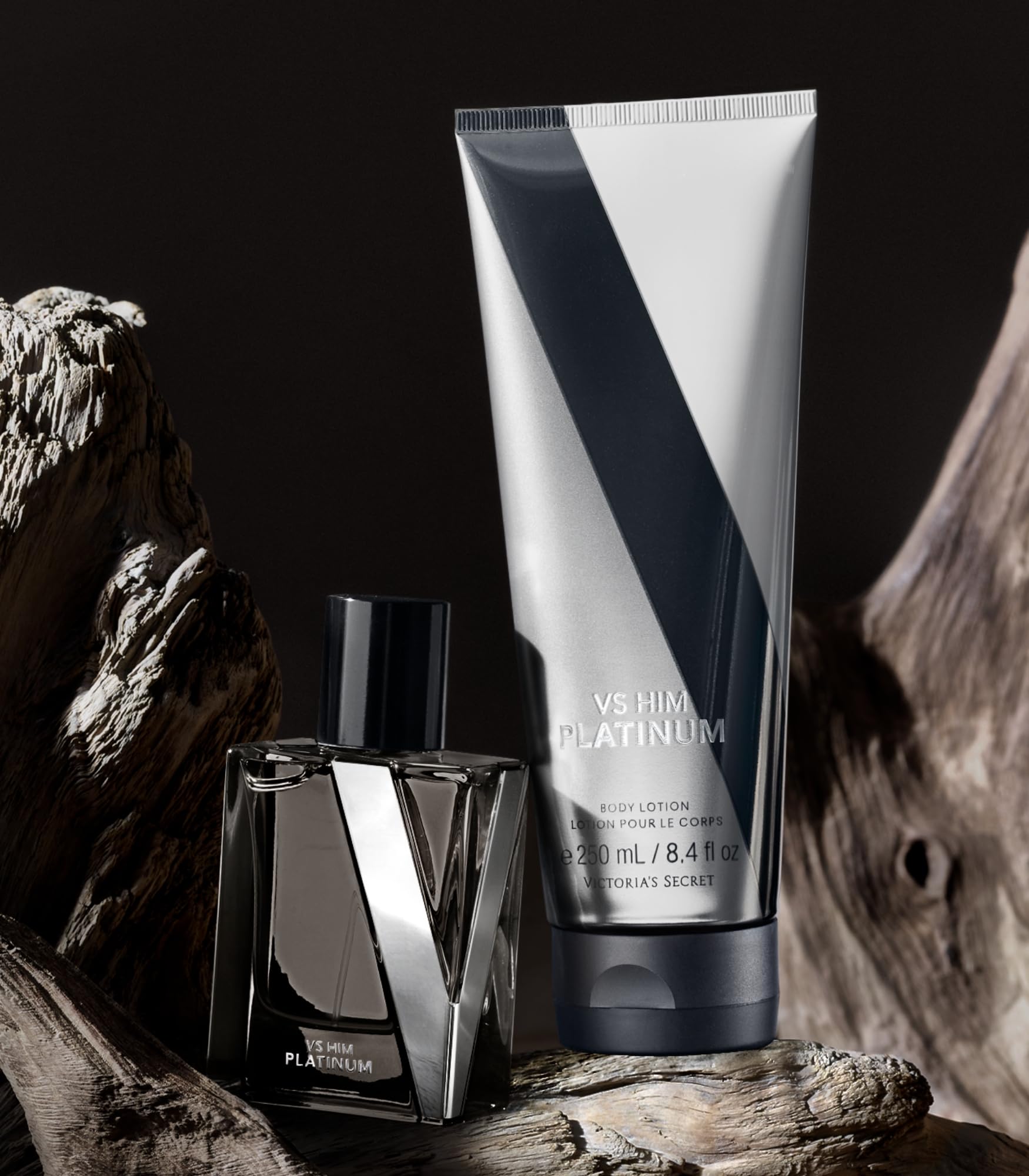 Victoria's Secret VS Him Platinum cologne bottle beside lotion for layering
