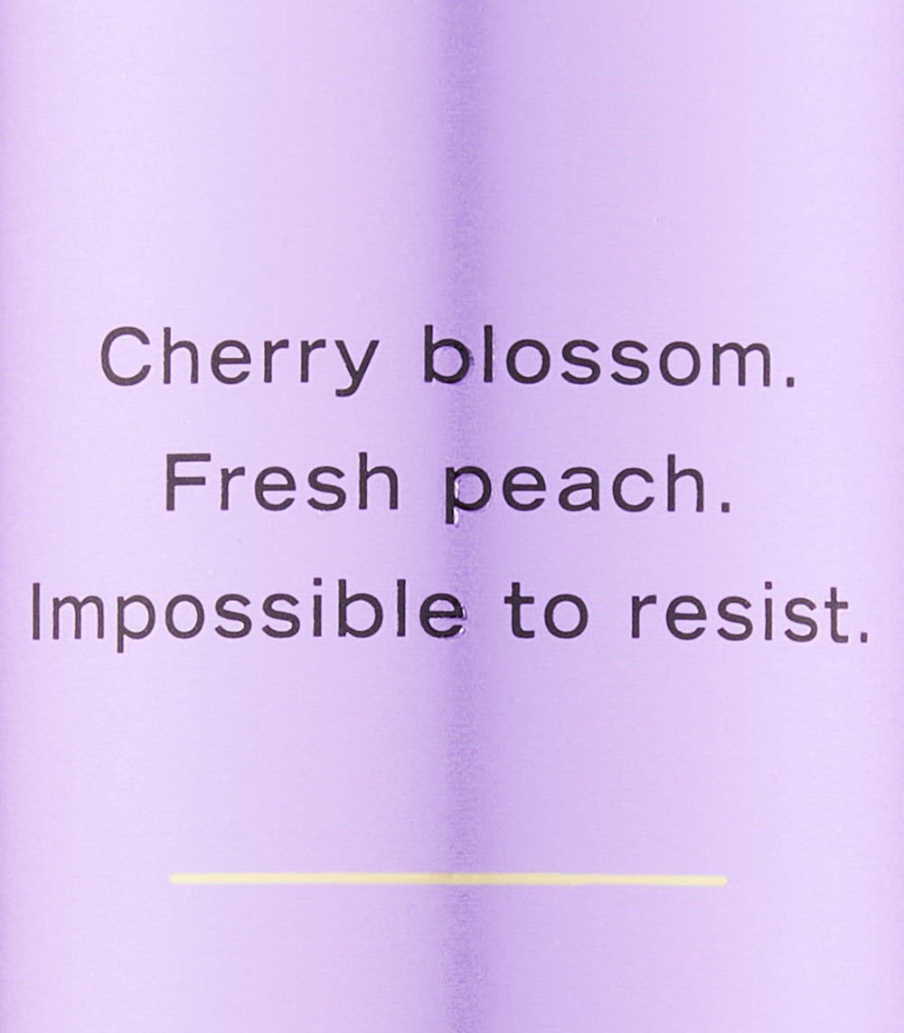 Victoria's Secret Love Spell spray action shows light mist for pulse-point use.