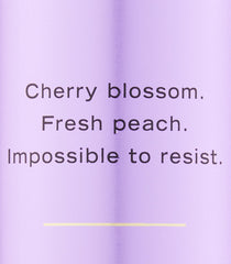 Victoria's Secret Love Spell spray action shows light mist for pulse-point use.