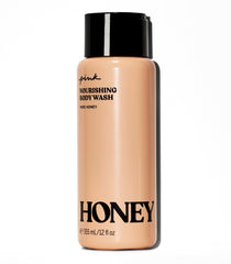 Victoria's Secret Pink Honey Nourishing Gel Body Wash bottle glows with honey-gold lather for nourishment.