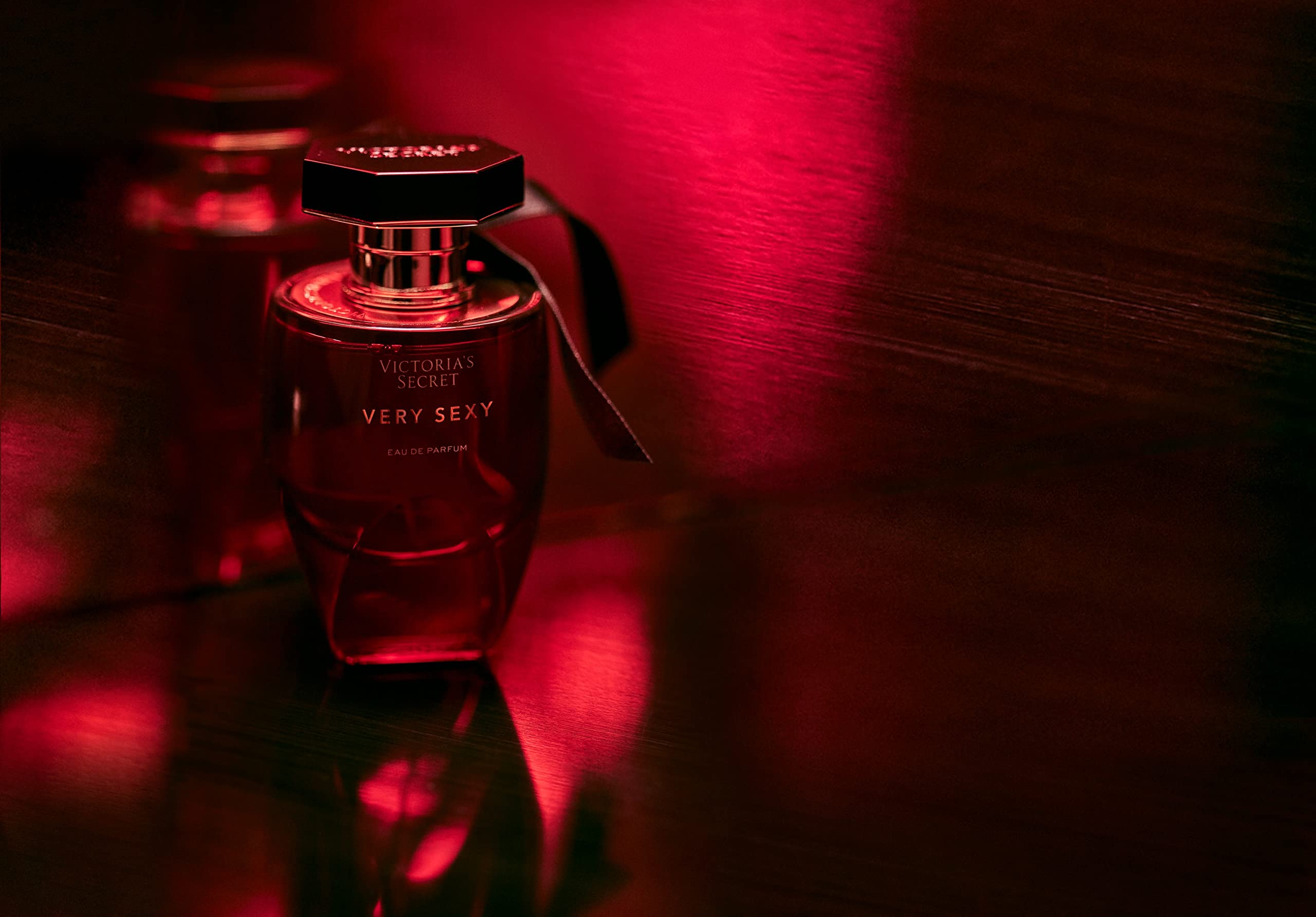 Victoria's Secret Very Sexy lifestyle image of applying perfume for confident moments.