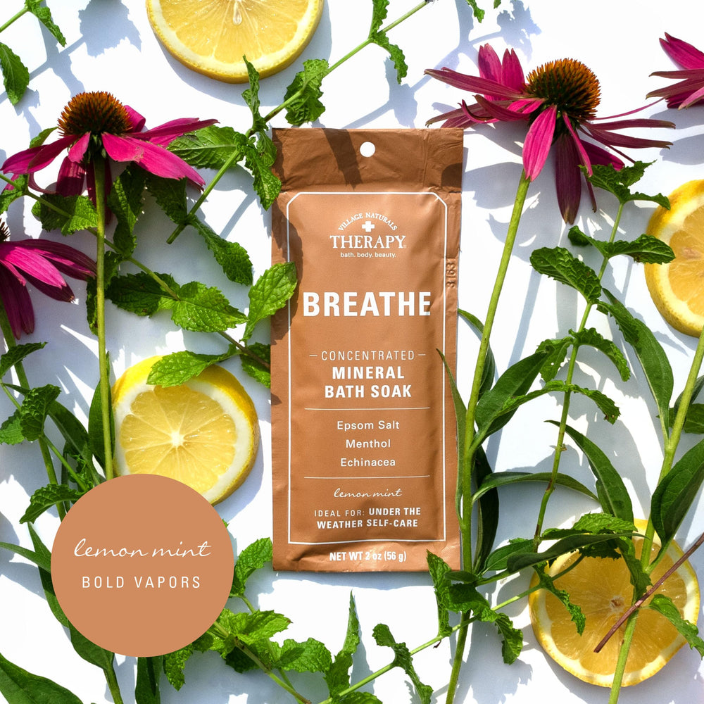 Village Naturals Therapy Breathe bath tub setup with steaming water and soothing lemon-mint aromatics