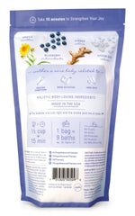 Village Naturals Therapy Comfort Foaming Bath Soak bottle closeup highlights cleansing bubbles and revitalizing scent.