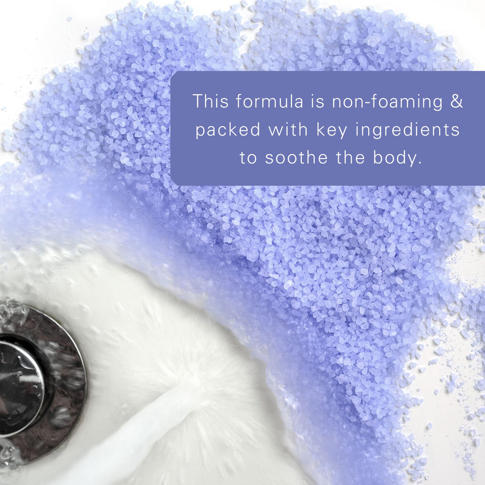 Village Naturals Therapy full-bath scene with foamy water for a relaxing home spa.