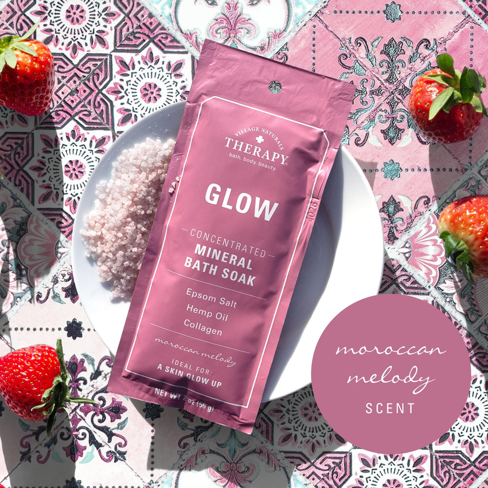 Village Naturals Therapy Glow bath soak pour close-up for aromatic stress-relief ritual