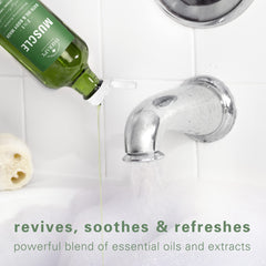 Village Naturals Therapy Muscle Foaming Bath Oil used with a pouf in shower.