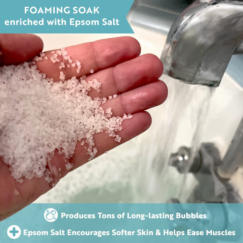 Village Naturals Therapy Hydrate foaming bath bubbles rise in a citrus tub