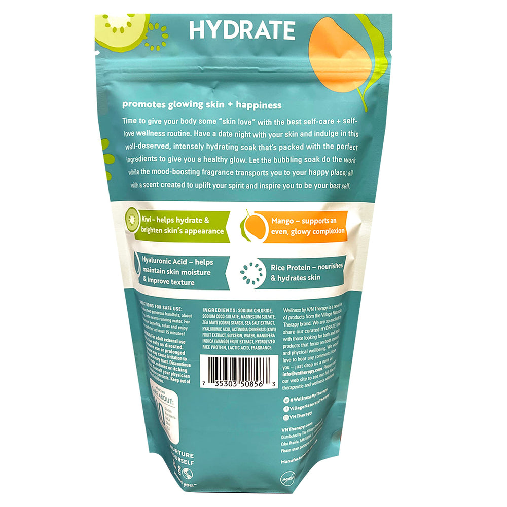 Village Naturals Therapy Hydrate Foaming Bath Soak being poured under warm water