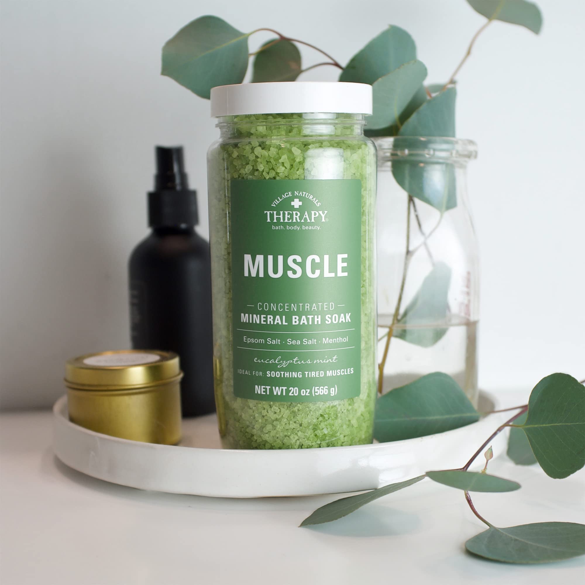 Village Naturals Therapy bottle label close-up emphasizes mint fragrance and mineral bath benefits