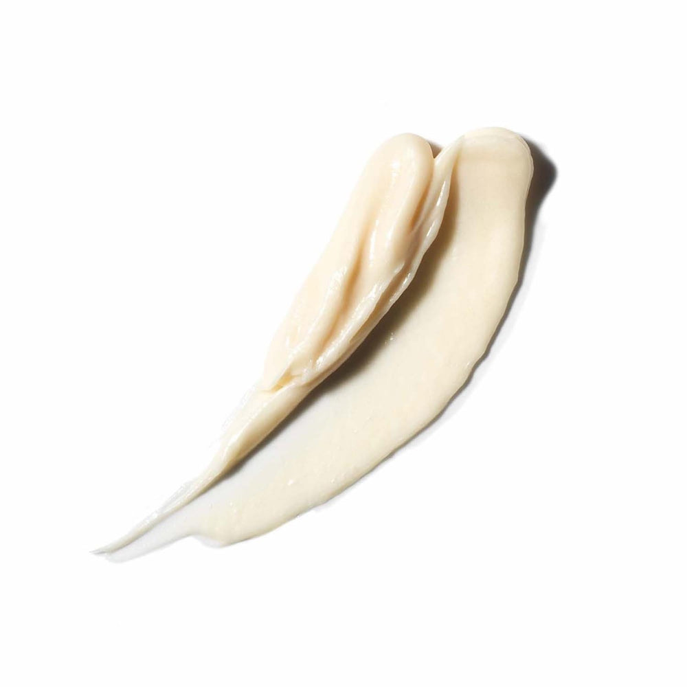 Hands distributing VIRTUE conditioner through damp hair for even coverage.
