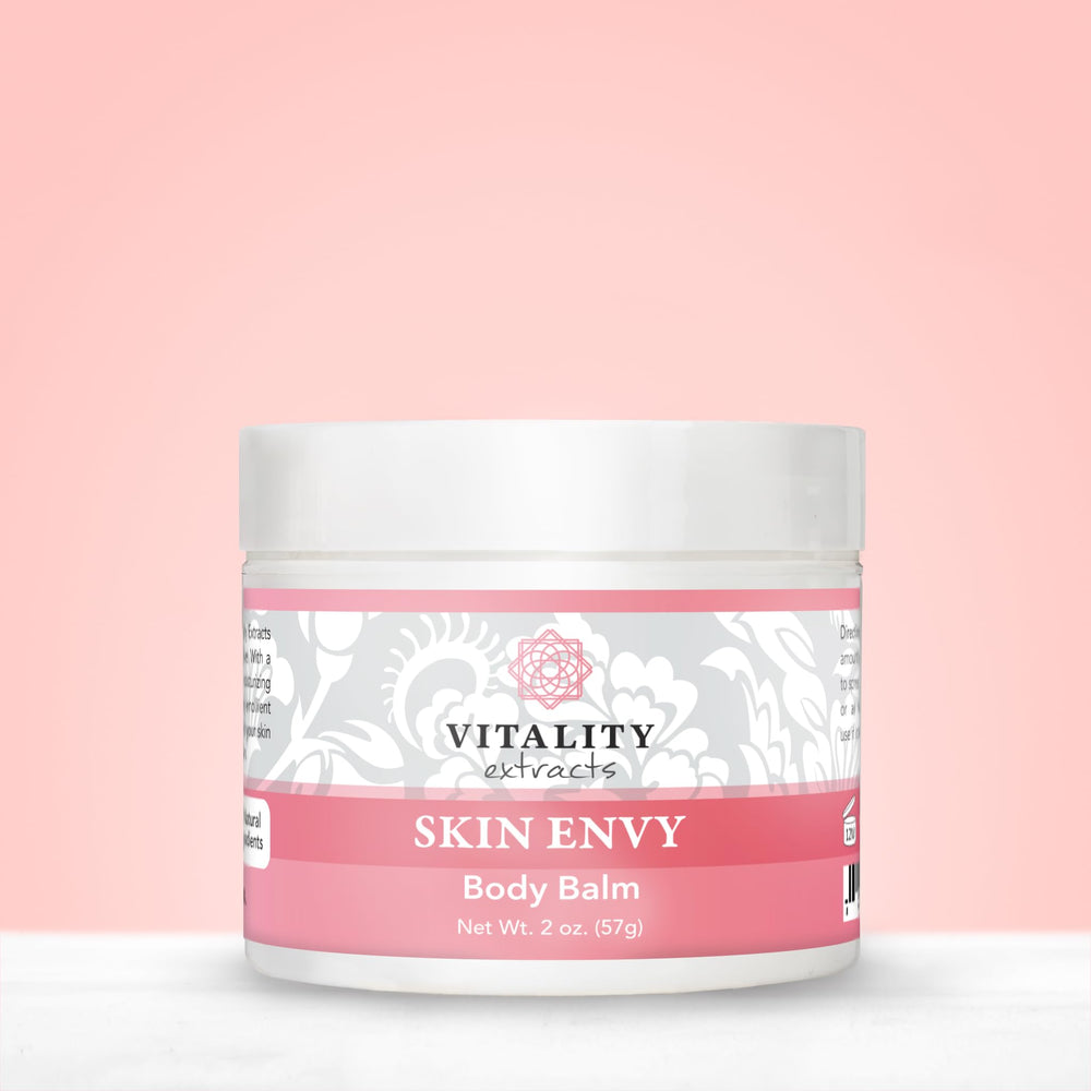 Vitality Skin Envy Balm ingredients flat lay highlighting natural oils and beeswax