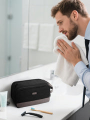 WANDF toiletry bag with mesh pouches holds bottles upright and accessible.