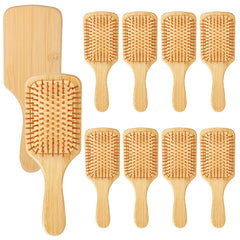 Wanmu bamboo hair brush with ergonomic paddle handle for comfortable detangling.
