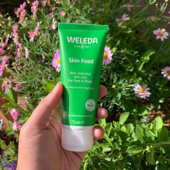 Weleda Skin Food on dry hands and elbows delivering lasting moisture.