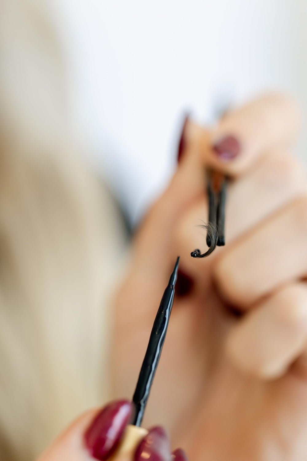 WINKCLIQUE eyelash adhesive packaging showcases black glue ideal for DIY extensions.