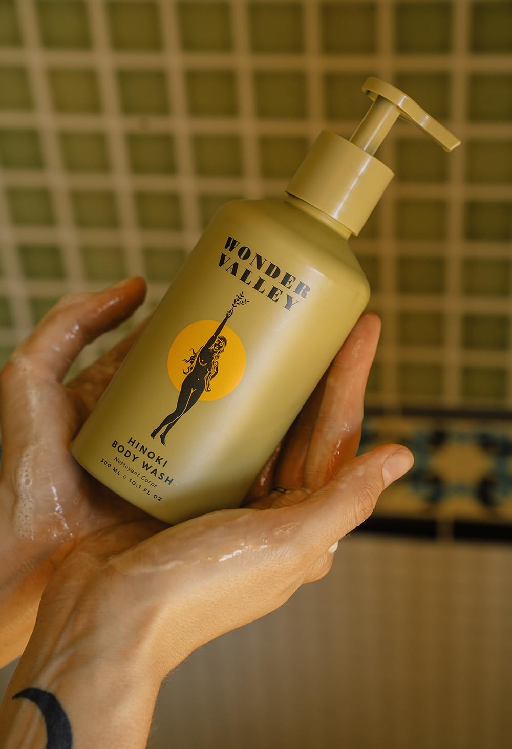 Wonder Valley Hinoki Body Wash applied to skin for silky, clean post-shower feel.