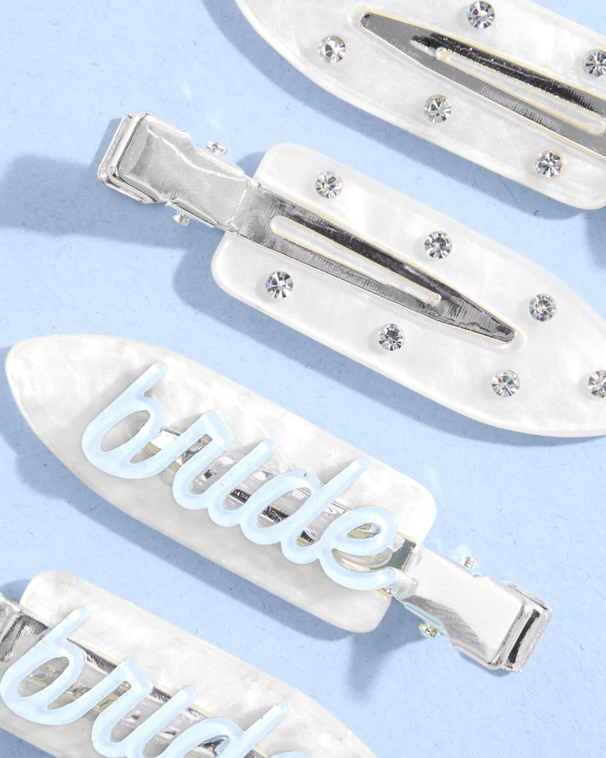 xo, Fetti Bride Beauty Clip with rhinestones adds subtle shine during wedding prep.