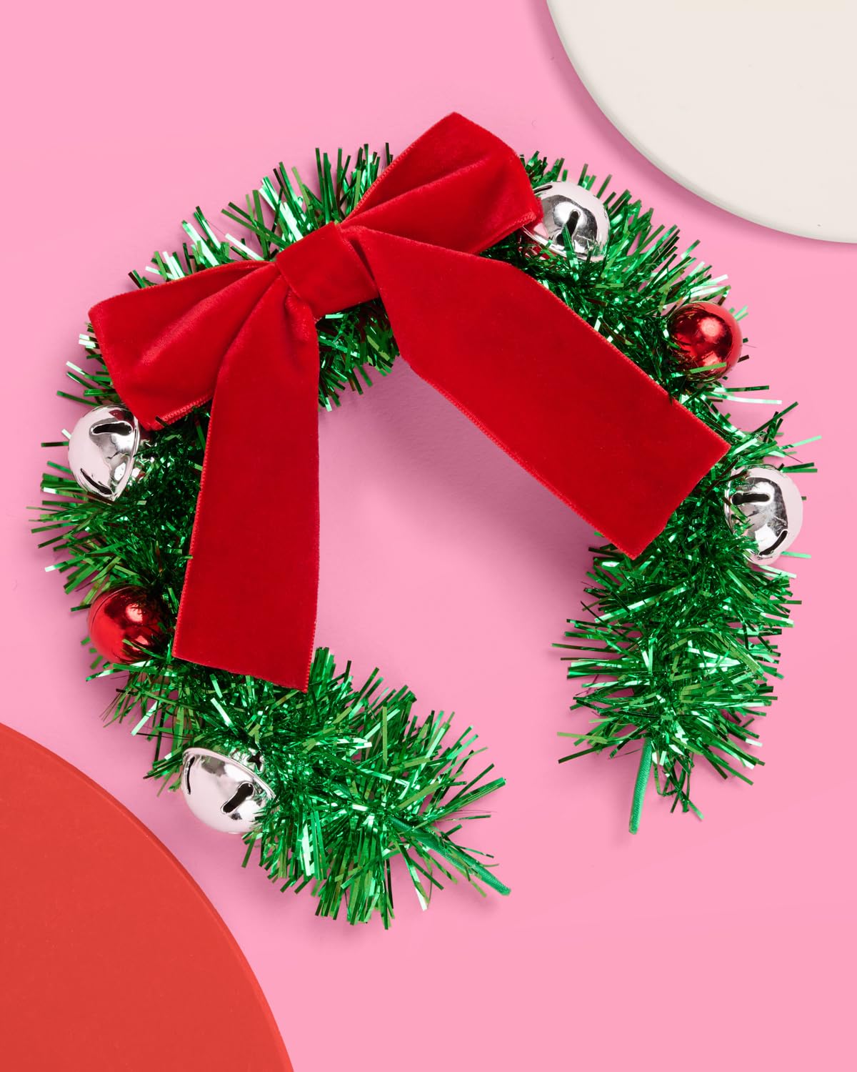 xo, Fetti wreath headband close-up with red ornaments for holiday charm
