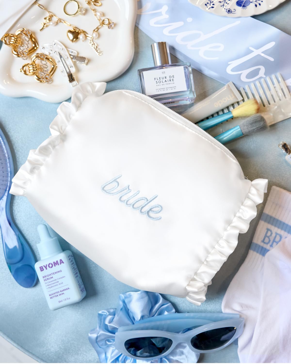 xo, Fetti open bag with makeup—demonstrates quick-access travel kit for brides.