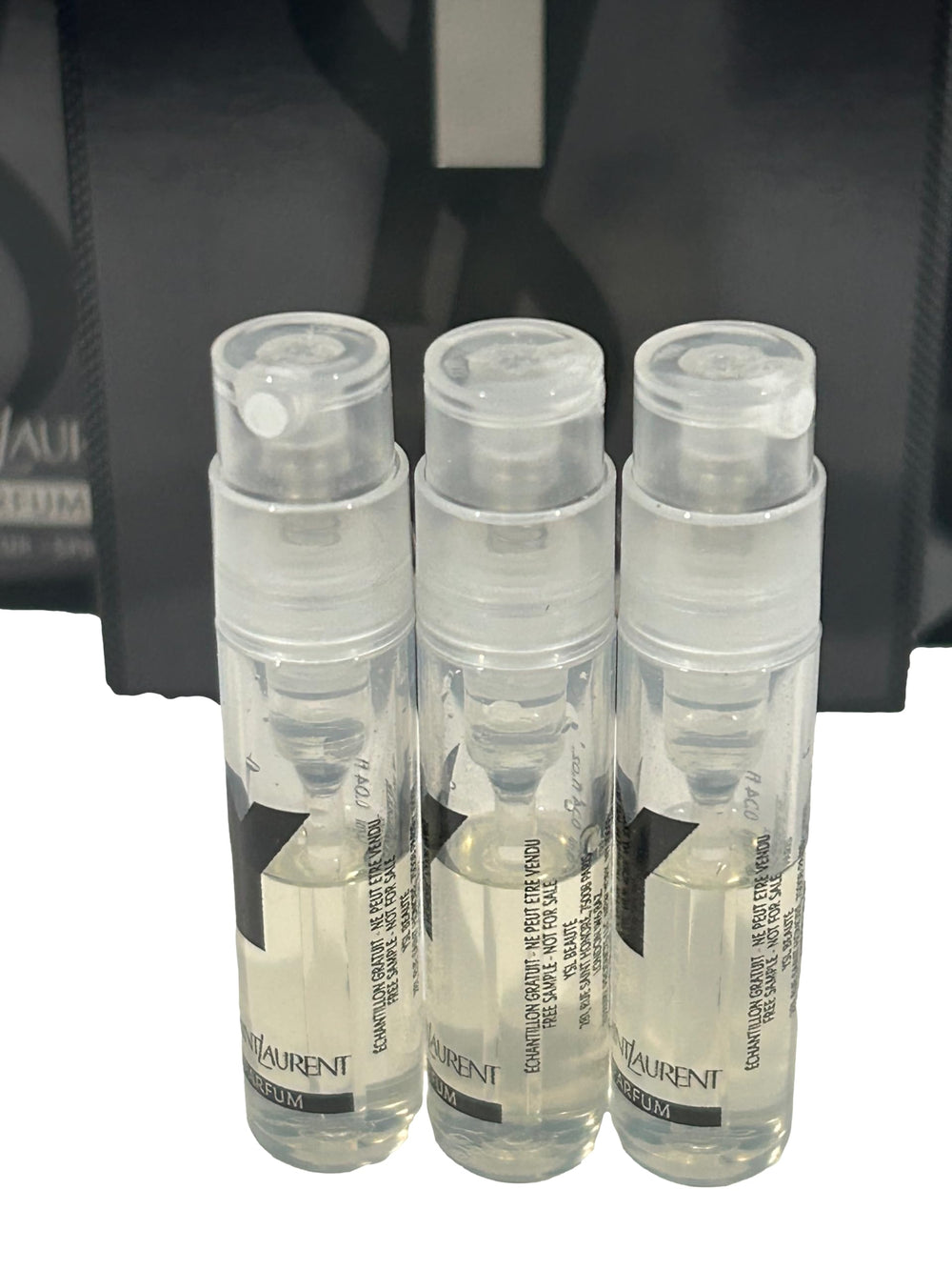 Yves Saint Laurent Y Men vial close-up showing partial fill for fragrance exploration.