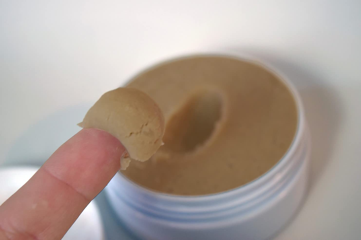 Zero Shine SPF small jar lid close-up shows texture and matte finish.