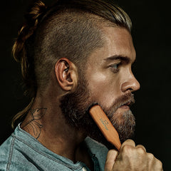 ZilberHaar beard brush in use by a gentleman for precise beard straightening.