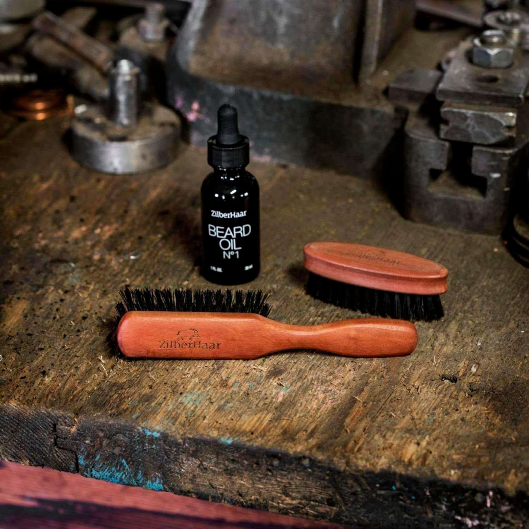 ZilberHaar beard brush shown with beard oil and balm for grooming routine.