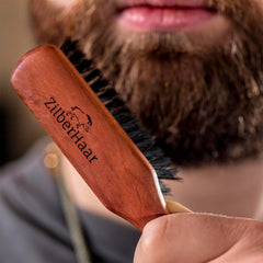 ZilberHaar Regular Beard Brush shown with beard oils and balms for pairing.
