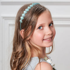 Ziricher bow headband highlights colorful details for versatile style accents.